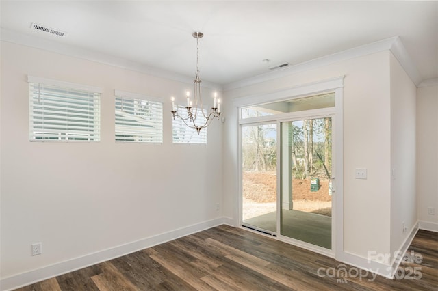 unfurnished dining area featuring ornamental molding, dark wood finished floors, visible vents, and baseboards