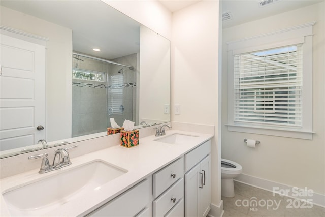 full bath featuring a sink, a shower stall, toilet, and tile patterned floors