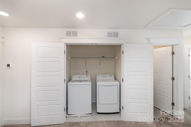 laundry room featuring laundry area, visible vents, light colored carpet, and washing machine and clothes dryer