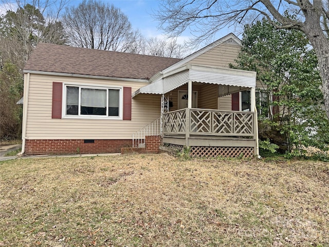 view of front of property with a shingled roof, crawl space, and a front lawn