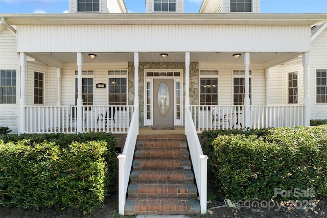 view of exterior entry featuring a porch