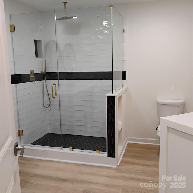 2545 Stockbridge Dr, Charlotte, NC 28210 - full bath featuring wood finished floors, vanity, a shower stall, and toilet