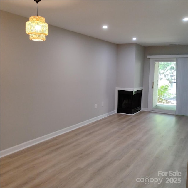 2545 Stockbridge Dr, Charlotte, NC 28210 - unfurnished living room with recessed lighting, light wood finished floors, a fireplace, and baseboards