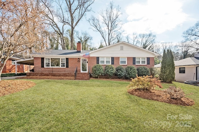 ranch-style home featuring an attached carport, a chimney, brick siding, and a front lawn