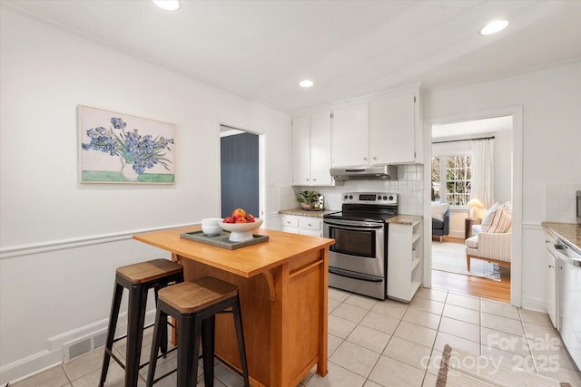 kitchen with tasteful backsplash, under cabinet range hood, light tile patterned flooring, electric range, and wood counters