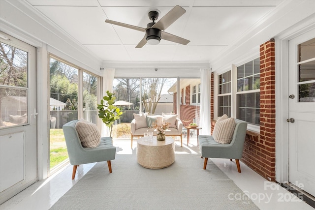 sunroom with plenty of natural light and ceiling fan