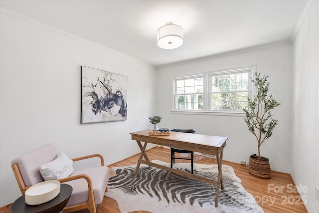 office with light wood-style flooring and ornamental molding