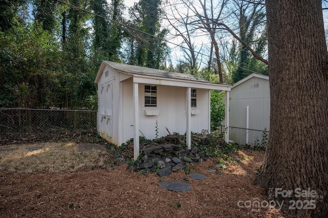 view of shed featuring fence