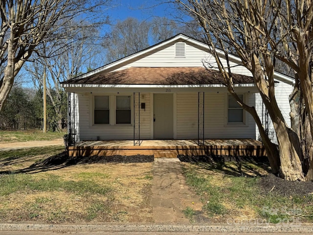 view of front of home with a porch and roof with shingles