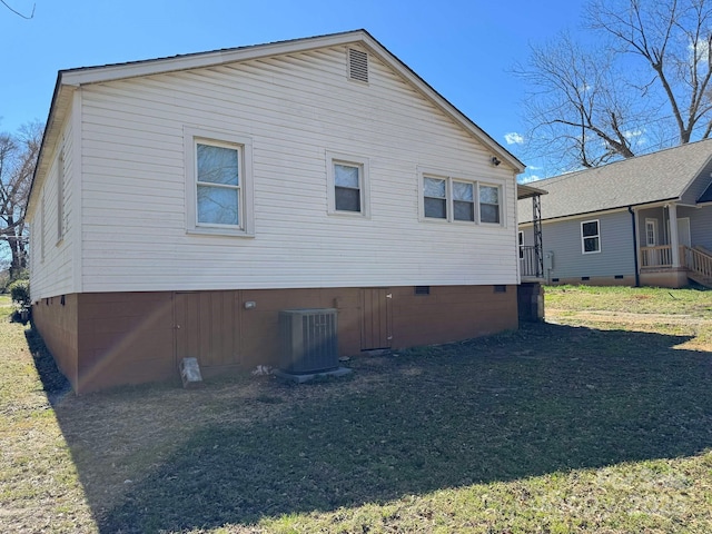 rear view of house featuring crawl space, a lawn, and central air condition unit