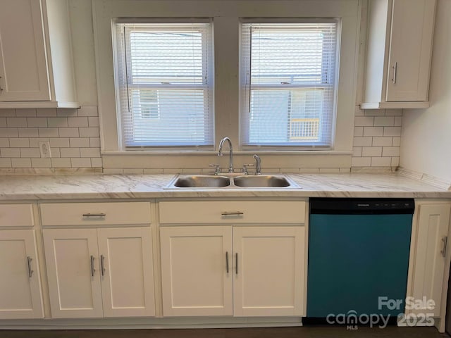 kitchen featuring a healthy amount of sunlight, white cabinets, a sink, and dishwashing machine