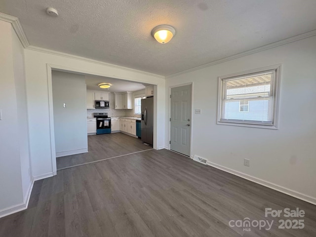 unfurnished living room with a textured ceiling, dark wood-style flooring, visible vents, baseboards, and crown molding