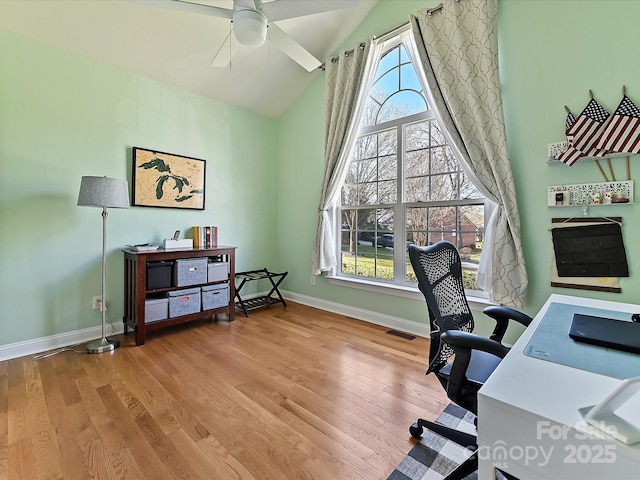 office with high vaulted ceiling, visible vents, baseboards, and wood finished floors