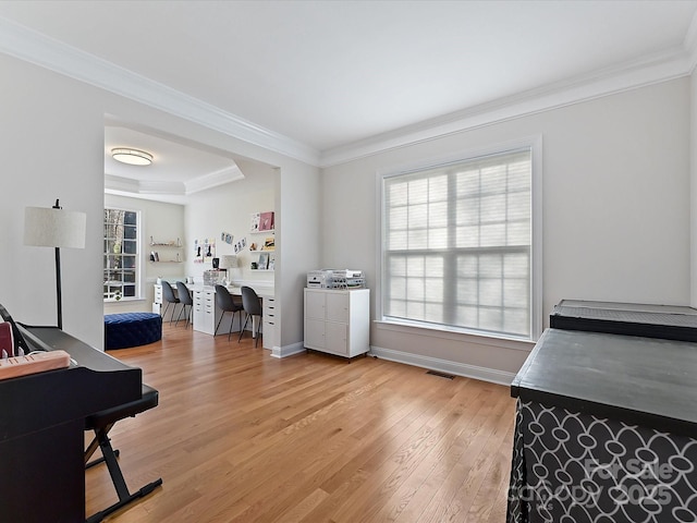 interior space with light wood-style floors, plenty of natural light, and crown molding