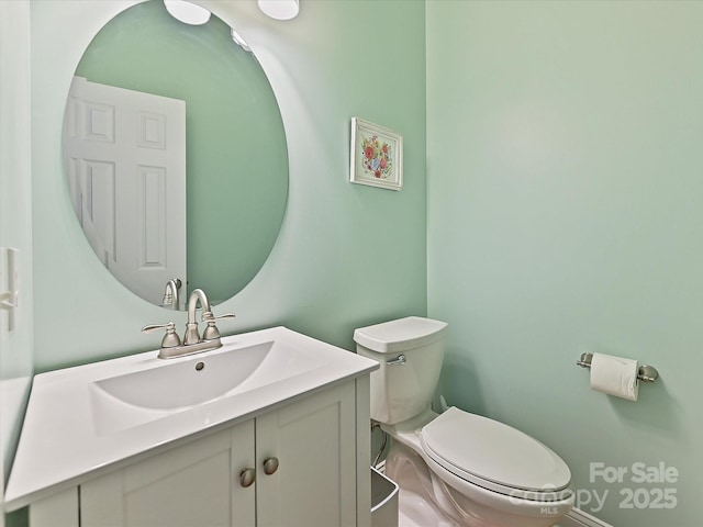 bathroom with toilet and vanity