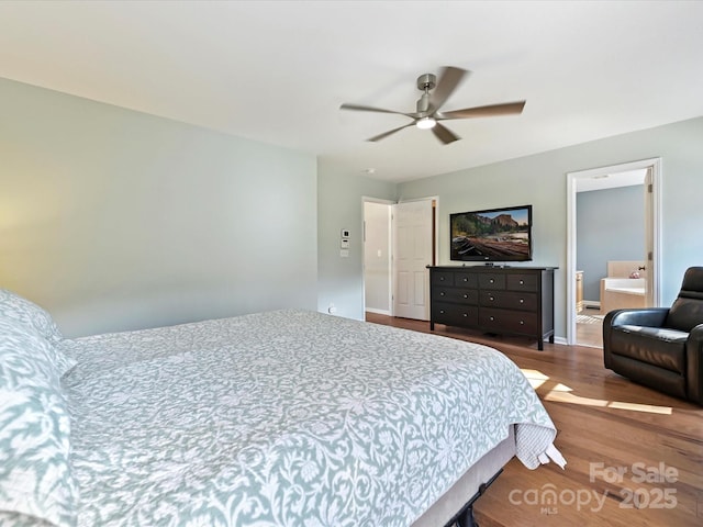 bedroom with ceiling fan, baseboards, and wood finished floors