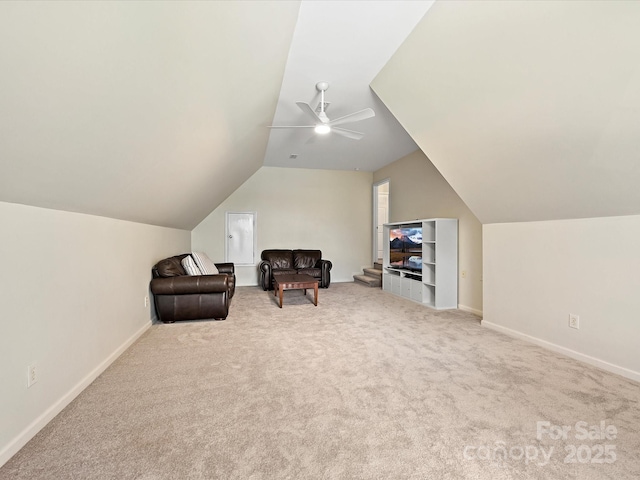 sitting room with vaulted ceiling, carpet, a ceiling fan, and baseboards