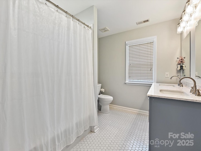 bathroom featuring toilet, baseboards, visible vents, and vanity