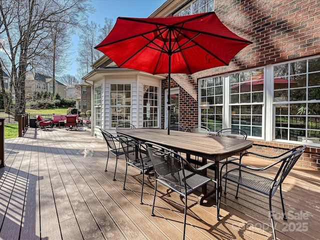 wooden deck featuring outdoor dining area