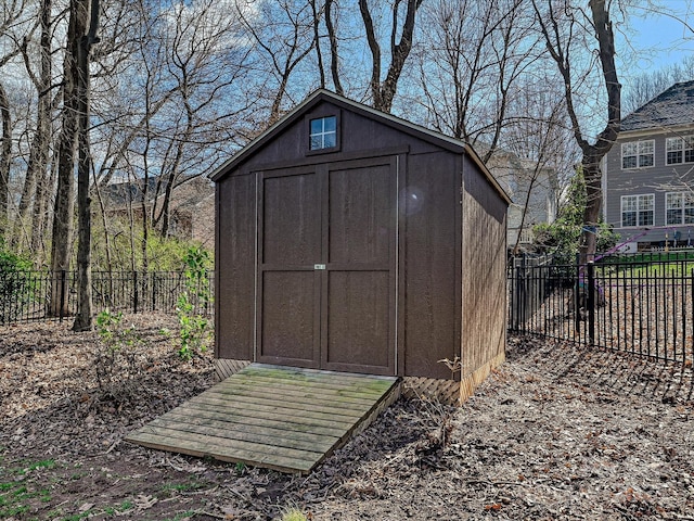 view of shed featuring fence