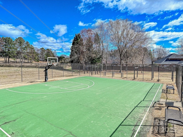 view of basketball court with community basketball court and fence