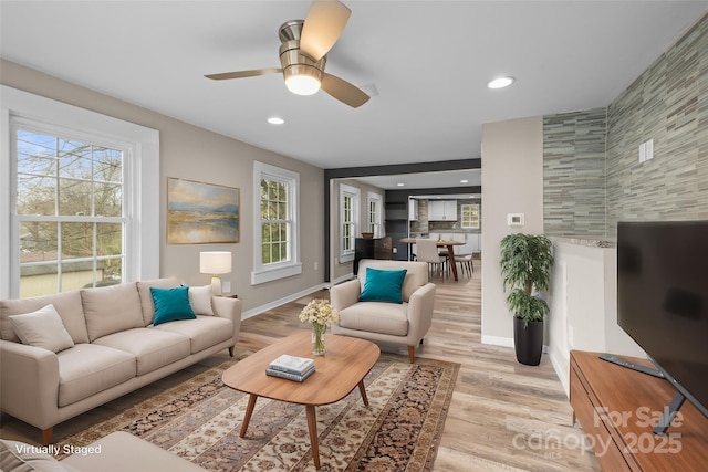 living area featuring light wood-style flooring, a healthy amount of sunlight, and recessed lighting
