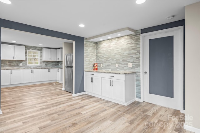 98 Ring Ave SW, Concord, NC 28025 - bar featuring freestanding refrigerator, tasteful backsplash, light wood-style floors, and recessed lighting