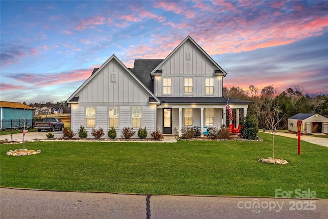 modern farmhouse featuring a lawn, board and batten siding, and covered porch