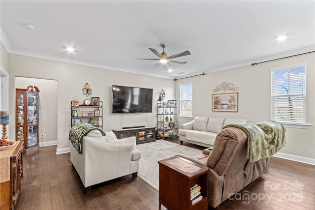 living room with dark wood finished floors, crown molding, and baseboards