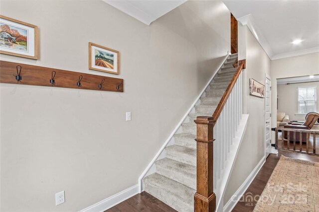 staircase with recessed lighting, baseboards, wood finished floors, and crown molding