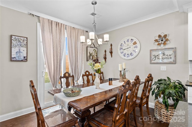 dining room with baseboards, a notable chandelier, wood finished floors, and ornamental molding