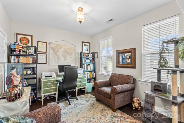 office featuring visible vents, baseboards, and wood finished floors