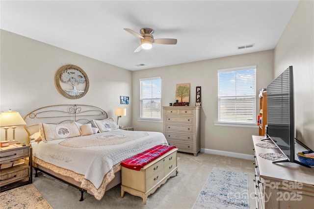 bedroom with multiple windows, baseboards, visible vents, and light carpet