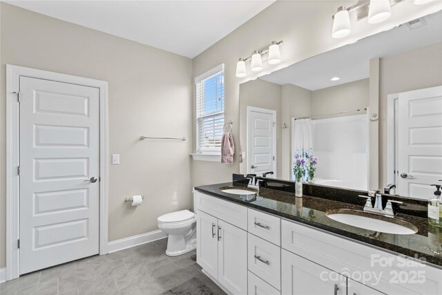 full bath with double vanity, toilet, a shower with curtain, and a sink