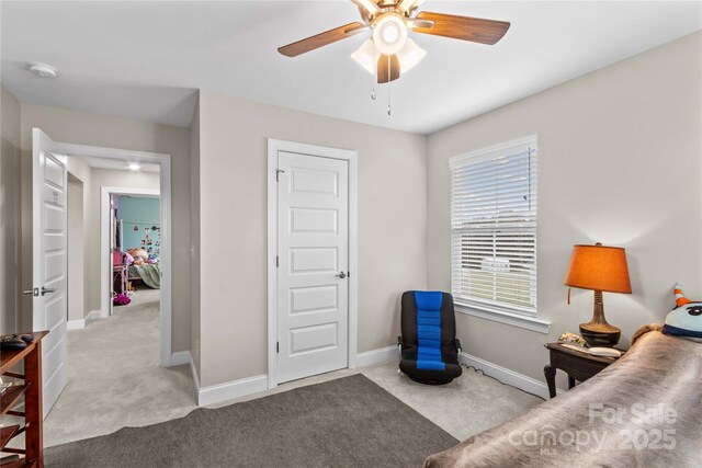 bedroom with ceiling fan, baseboards, and carpet floors