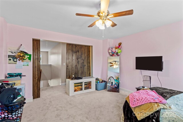 playroom featuring attic access, carpet flooring, a ceiling fan, and baseboards