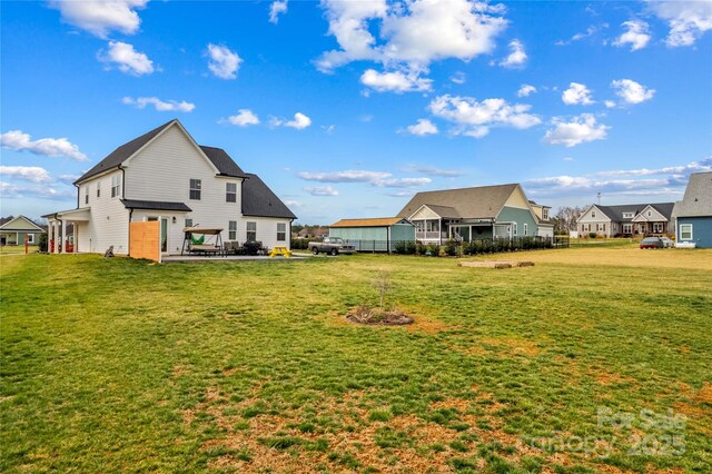 view of yard featuring a patio area and a residential view