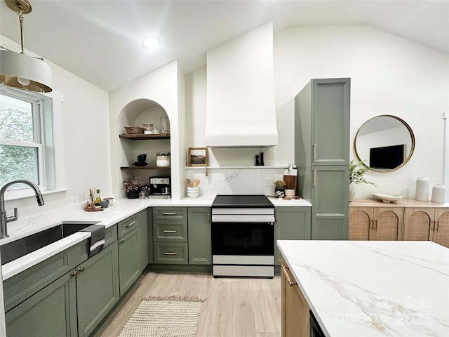 kitchen with range with electric stovetop, a sink, vaulted ceiling, custom range hood, and green cabinetry