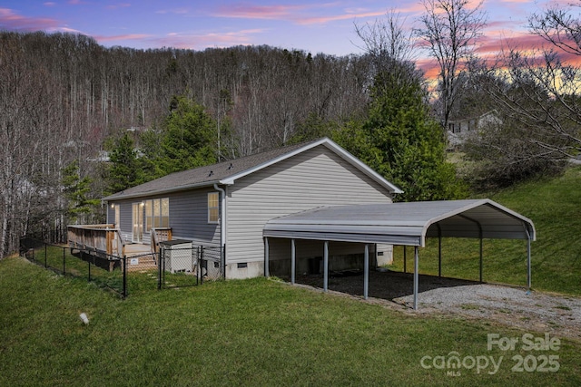 6 Clark Meadow Ln, Candler, NC 28715 - back of house at dusk featuring a gate, gravel driveway, crawl space, a view of trees, and a yard