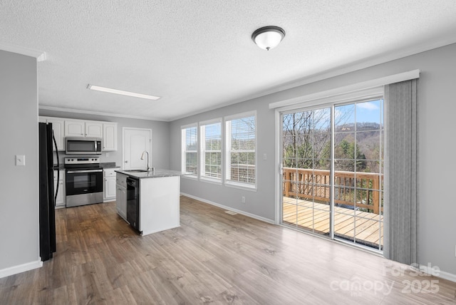 6 Clark Meadow Ln, Candler, NC 28715 - kitchen featuring white cabinetry, a sink, wood finished floors, and appliances with stainless steel finishes