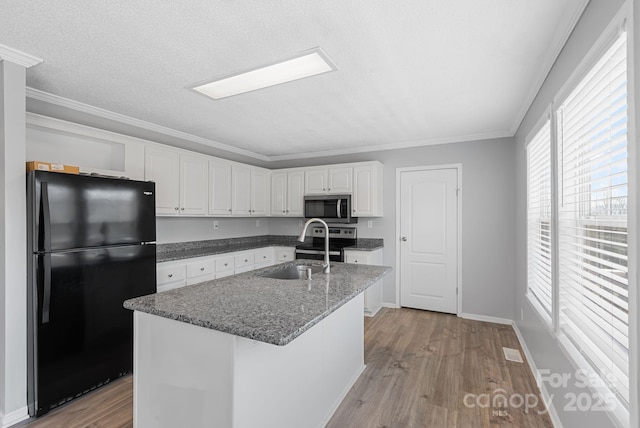 6 Clark Meadow Ln, Candler, NC 28715 - kitchen with white cabinets, ornamental molding, appliances with stainless steel finishes, a sink, and light wood-style floors