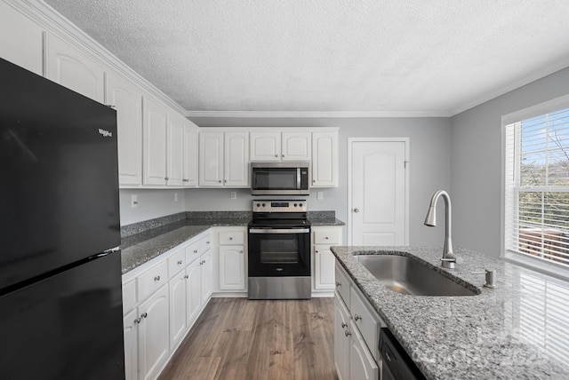 6 Clark Meadow Ln, Candler, NC 28715 - kitchen with white cabinets, wood finished floors, appliances with stainless steel finishes, dark stone countertops, and a sink