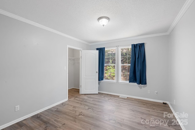 6 Clark Meadow Ln, Candler, NC 28715 - spare room with ornamental molding, a textured ceiling, baseboards, and wood finished floors