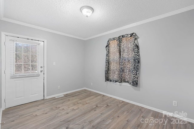 6 Clark Meadow Ln, Candler, NC 28715 - unfurnished room with a textured ceiling, ornamental molding, visible vents, and wood finished floors