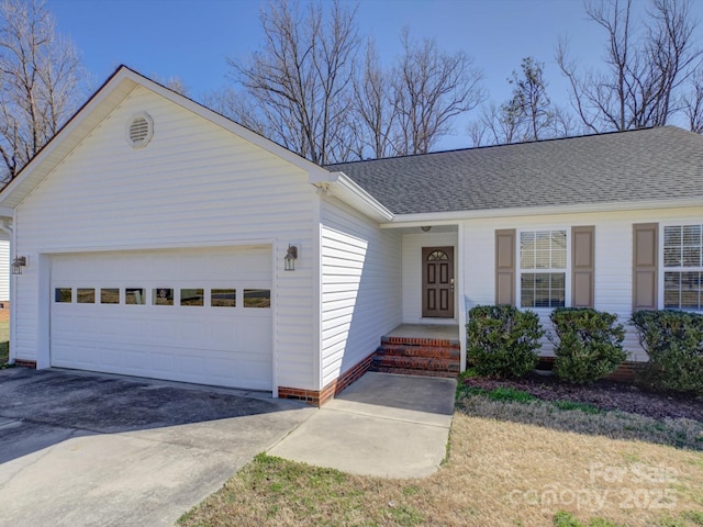 ranch-style house featuring a shingled roof, concrete driveway, and an attached garage