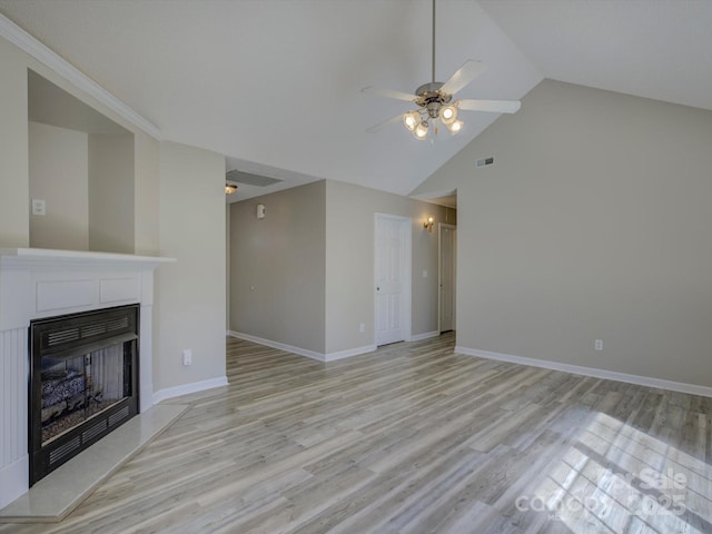 unfurnished living room with visible vents, a fireplace with raised hearth, light wood-style flooring, a ceiling fan, and baseboards