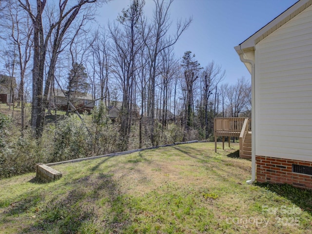 view of yard with stairs and a wooden deck