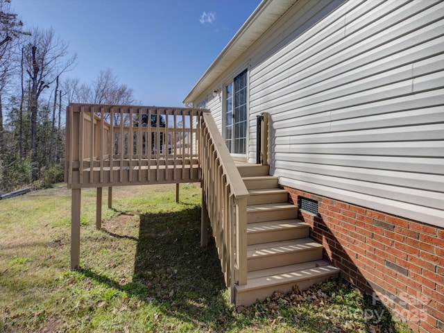 deck with stairway and a yard