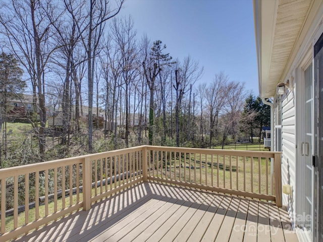 wooden deck featuring a yard