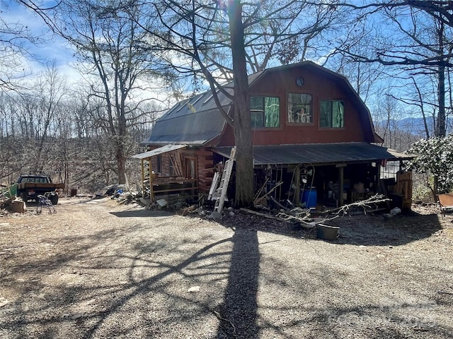 exterior space with a barn, metal roof, and a gambrel roof